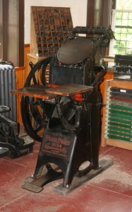 An old wood and metal printing press.