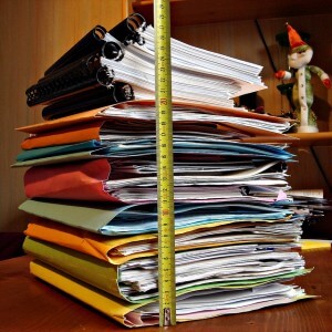 A stack of colorful binders and folders.